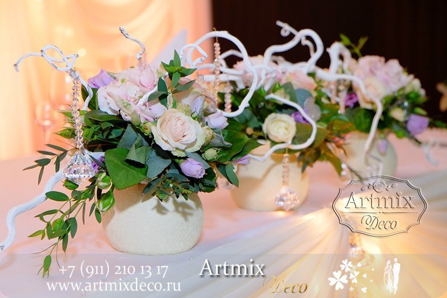 Цветы в вазах на свадебном торжестве с декором.